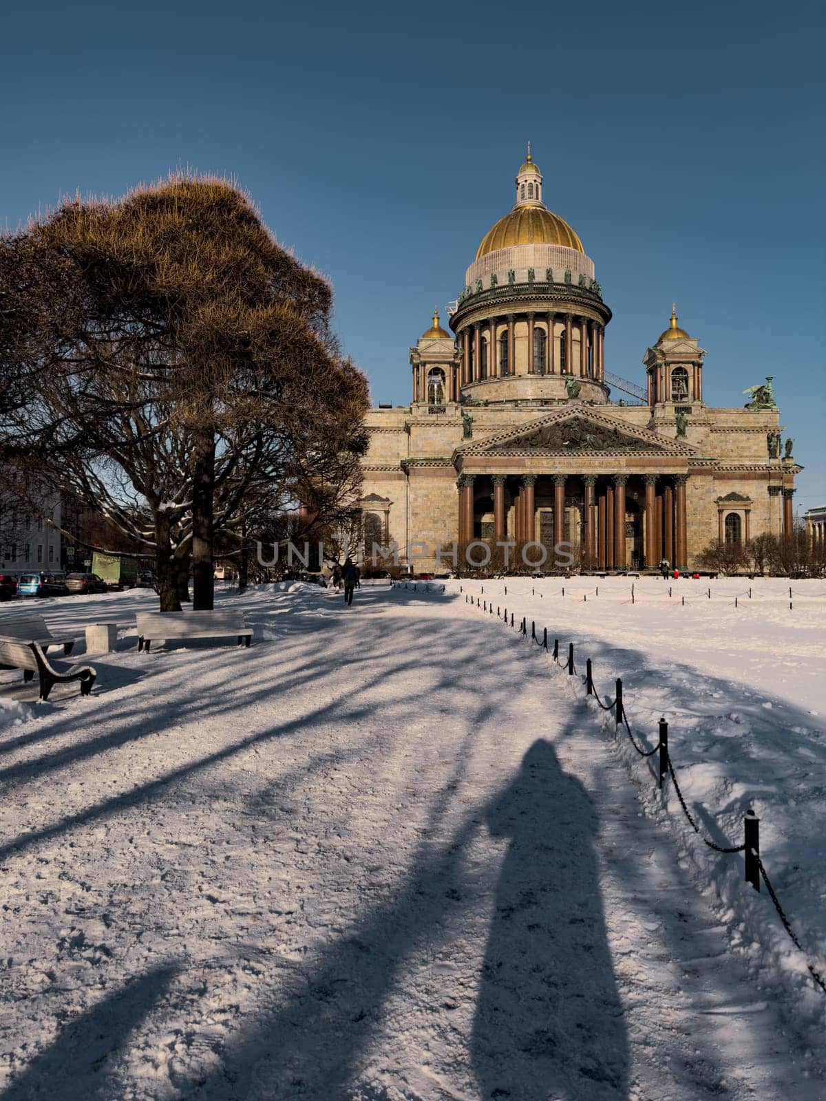 Snow-covered Park in front of St. Isaac's Cathedral in St. Petersburg - Russia in the spring sun by vladimirdrozdin