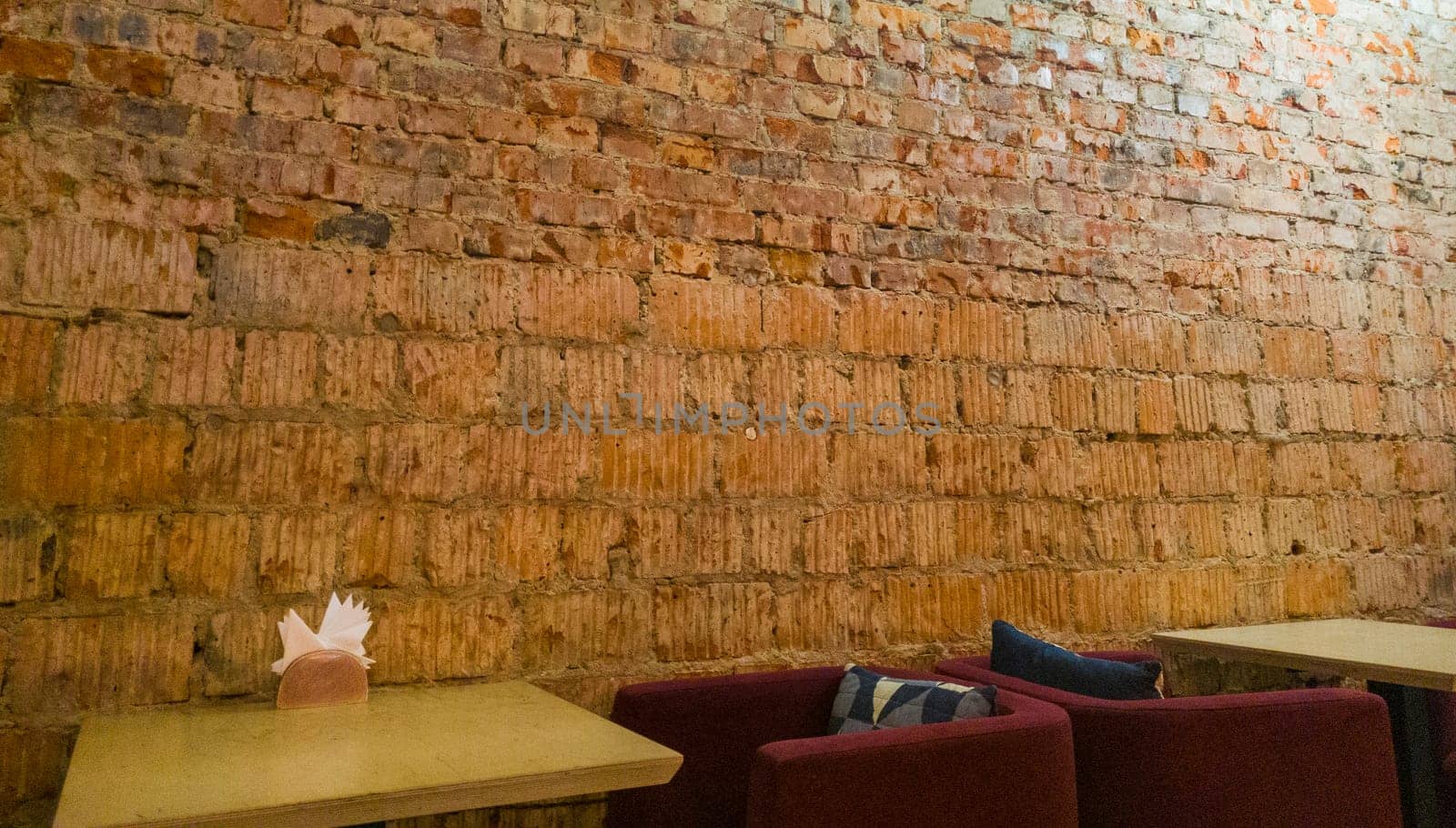Concept shot of the brick wall as a part of interior design of the cafe