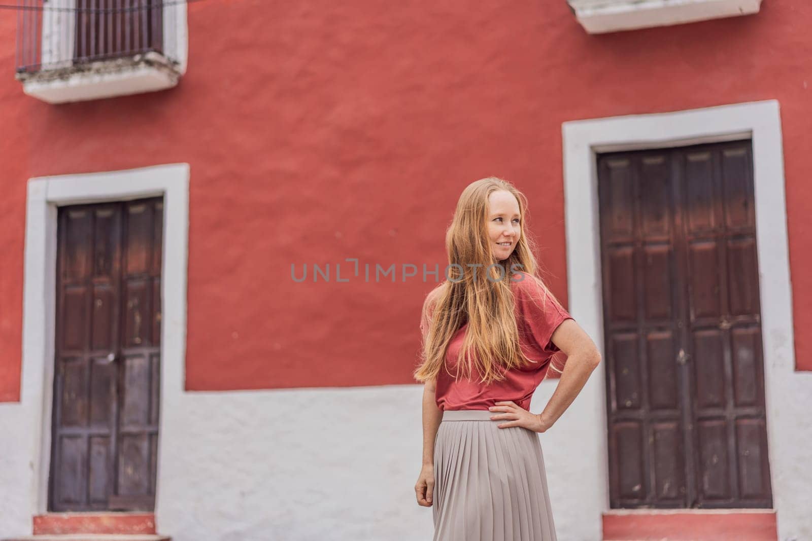 Woman tourist explores the vibrant streets of Valladolid, Mexico, immersing herself in the rich culture and colorful architecture of this charming colonial town by galitskaya