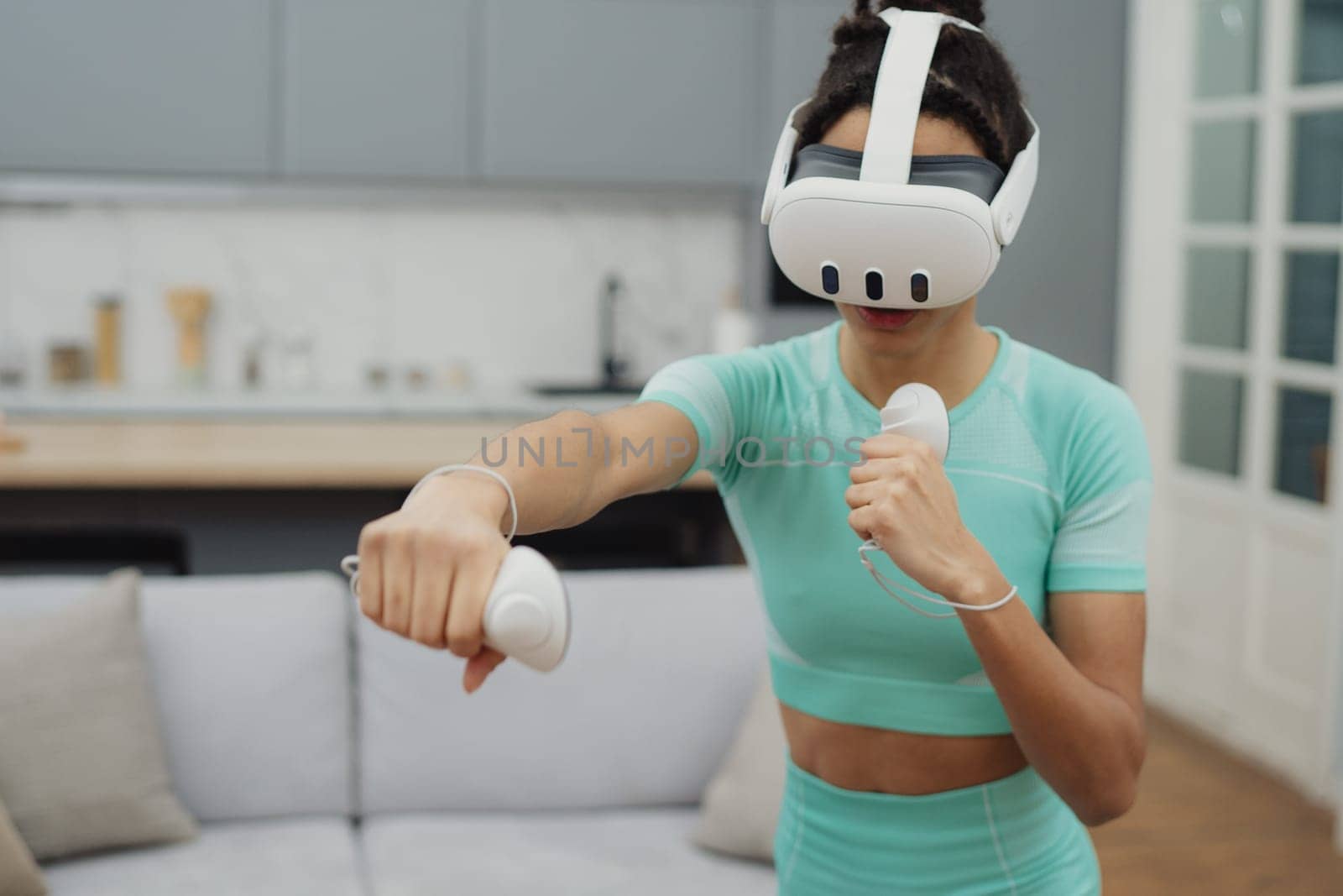 Training to become the best. Beautiful young woman in sports clothing exercising at home.