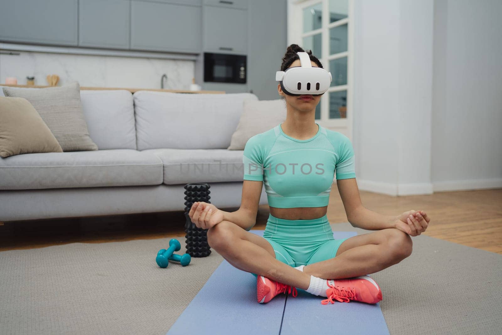 Training to become the best. Beautiful young woman in sports clothing exercising at home.