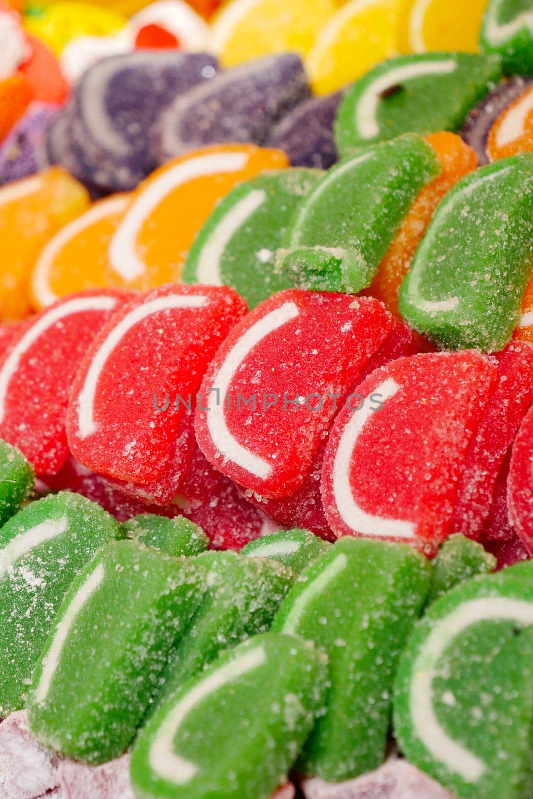 sugar coated jelly beans in the form of colored sliced fruit.