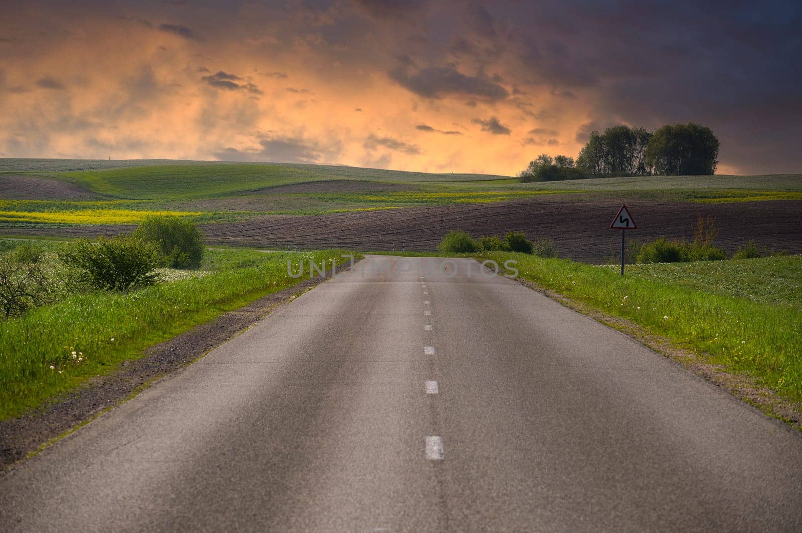 Asphalt road running through countryside landscape by NetPix
