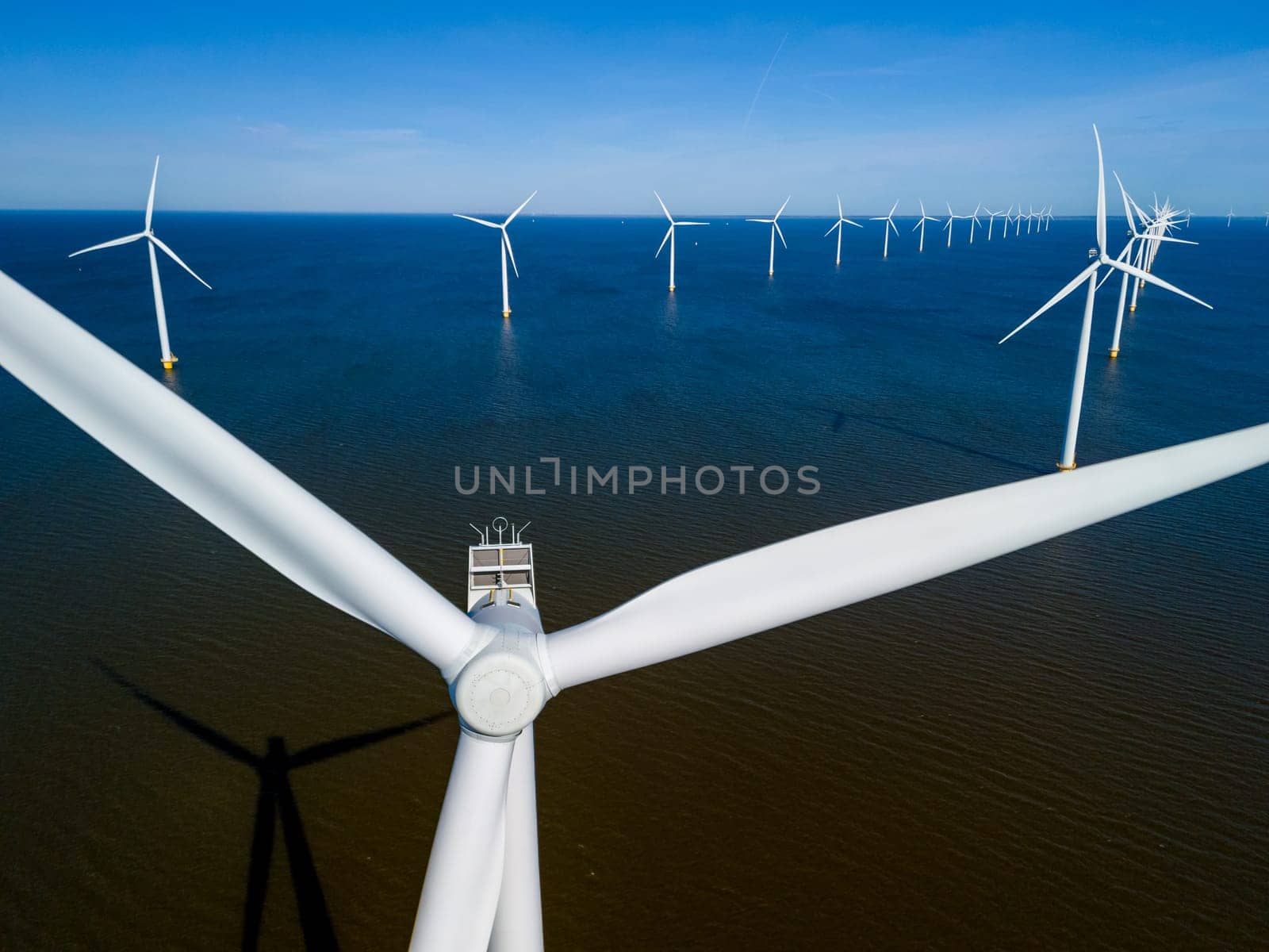 wind turbines the power of the wind to generate clean energy in Flevoland, Netherlands by fokkebok