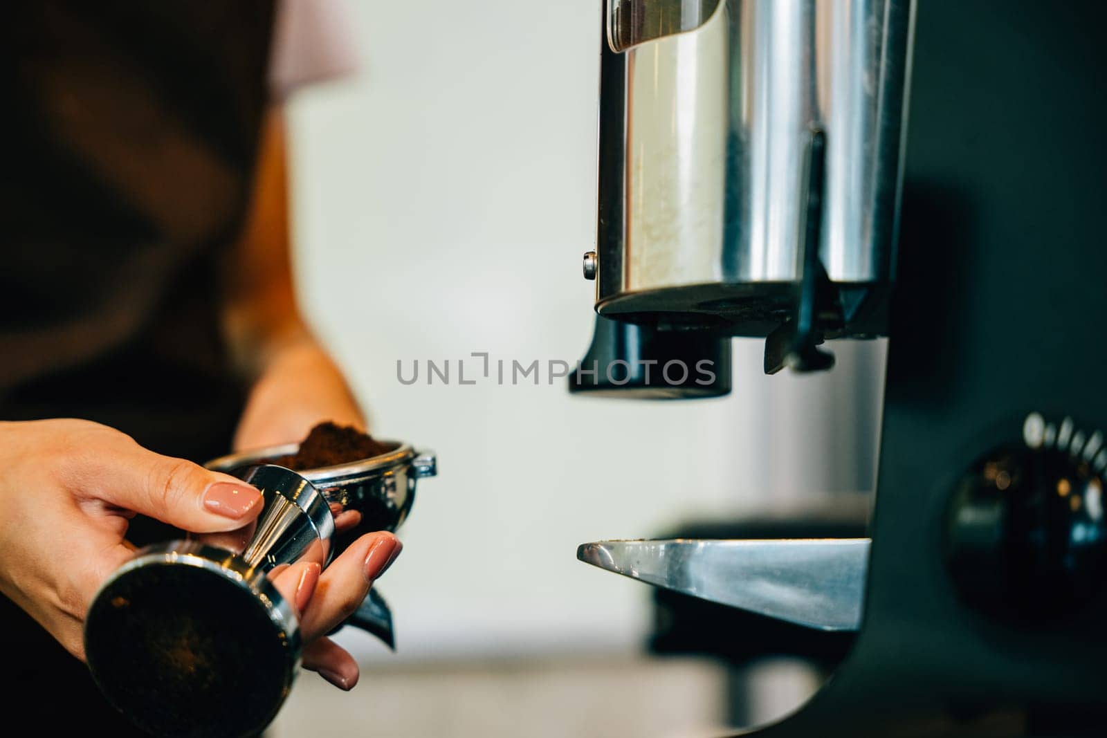 Fresh tasty coffee brewed by coffee machine in cafe or pub. Step by step guide to professional coffee making. Close up of machine hand holding handle pouring espresso. by Sorapop