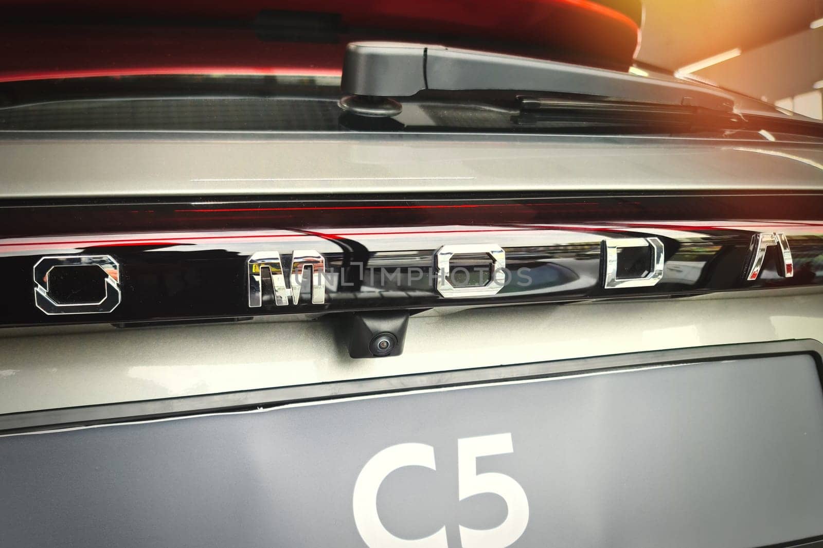 Close-up of the rear trunk door of a new Chinese OMODA C5 car by Rom4ek