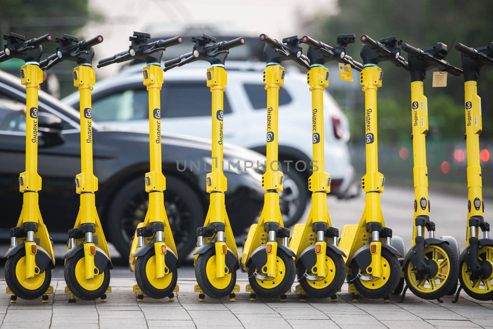 A lot of electric kicksharing from Yandex go, ready for rent. choice between types city transport, electric scooter or personal car by Rom4ek