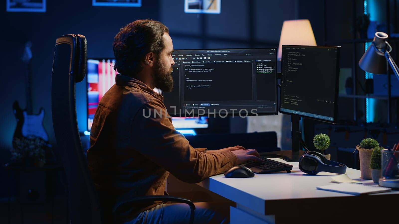Programmer developing code on computer screen while in personal office using java programming languages. IT admin working with software tool, fixing database errors while working from home, camera A