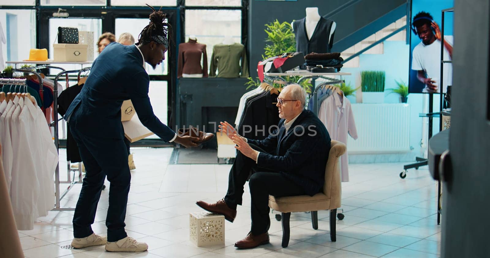 Elderly customer shopping for new shoes to match his elegant suit by DCStudio