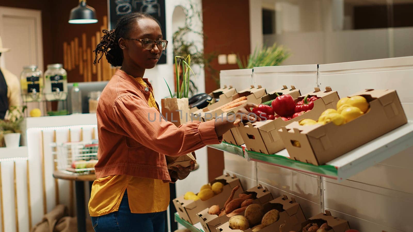 African american buyer choosing organic produce from crates by DCStudio