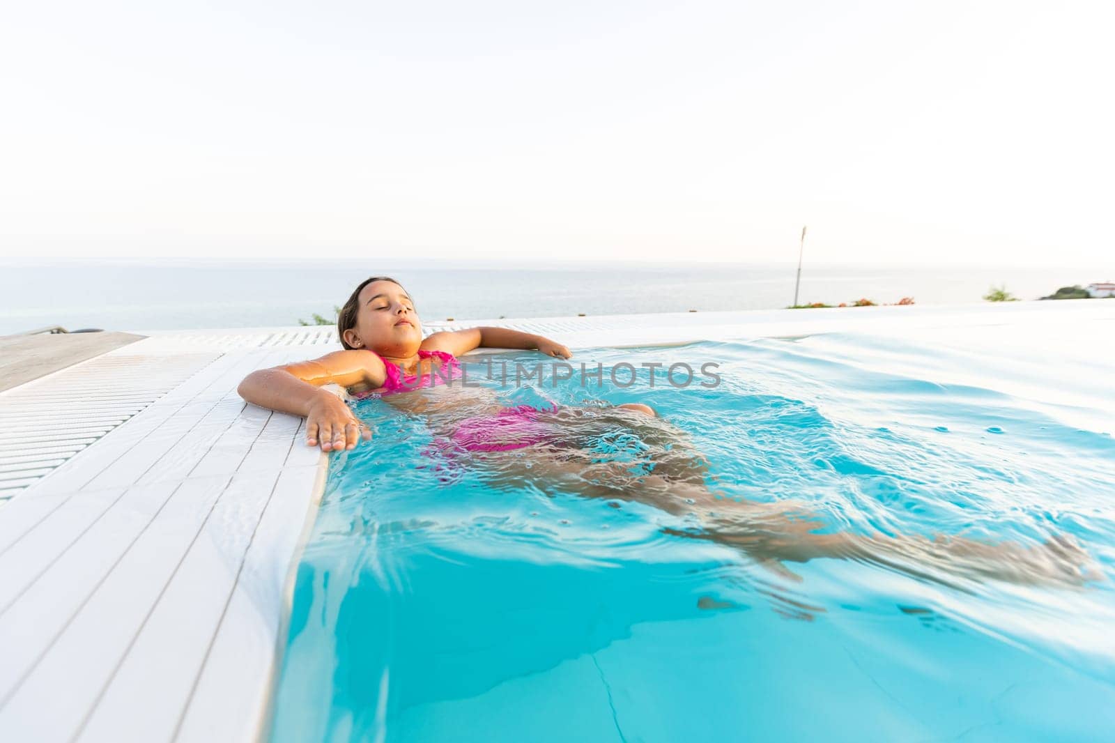 Young girl posing near swimming pool