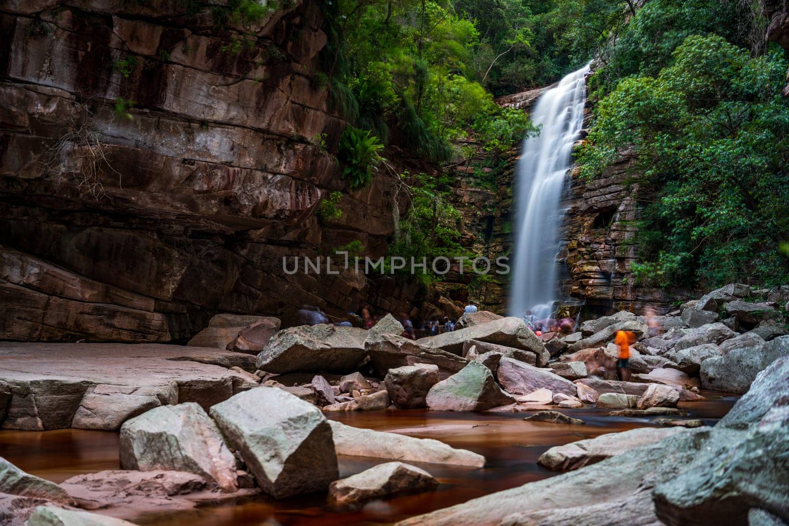 Serene Waterfall Oasis Amidst Rugged Rocks and Greenery by FerradalFCG