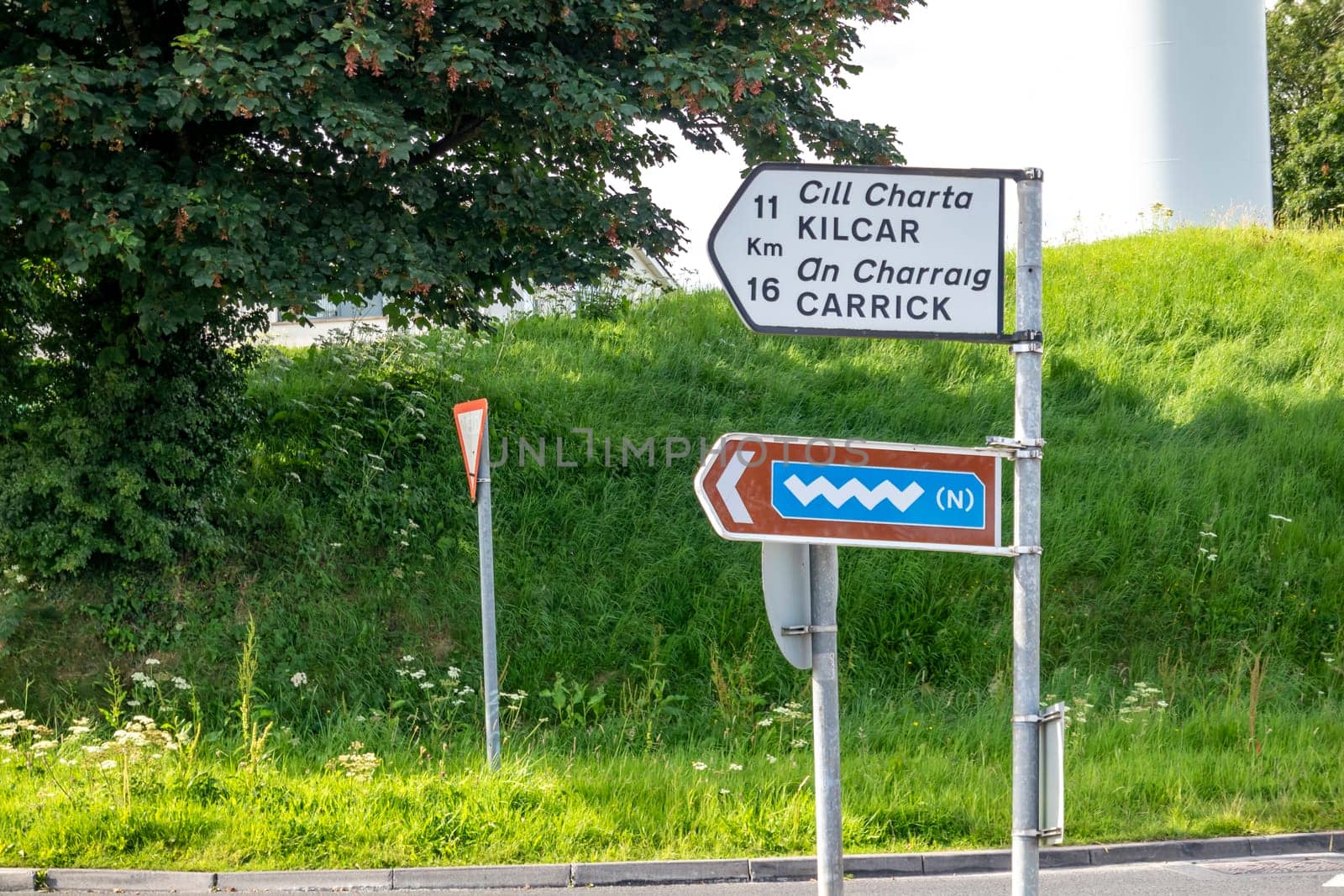 KILLYBEGS, IRELAND - MAY 16 2023: The sign at the roundabout is showing the way to Kilcar and Carrick.