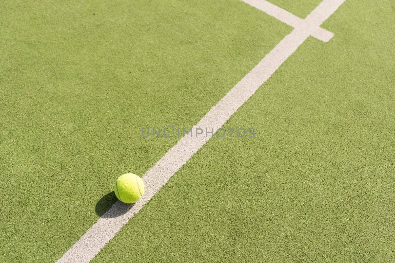 Tennis ball on a tennis court next to the side line. High quality photo