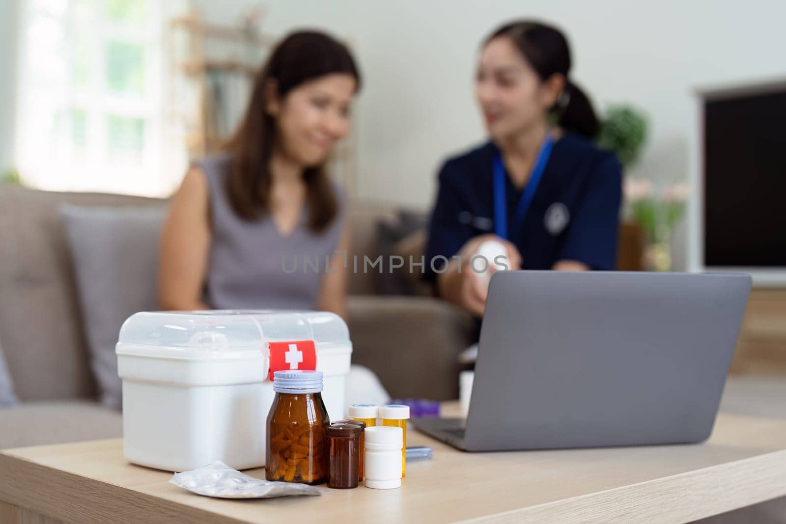 nurse visiting elderly patient at home is recommending medicine to elderly patient at home by itchaznong