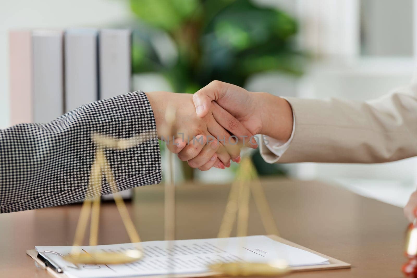 Lawyer handshake between attorney and client in professional law firm office by itchaznong