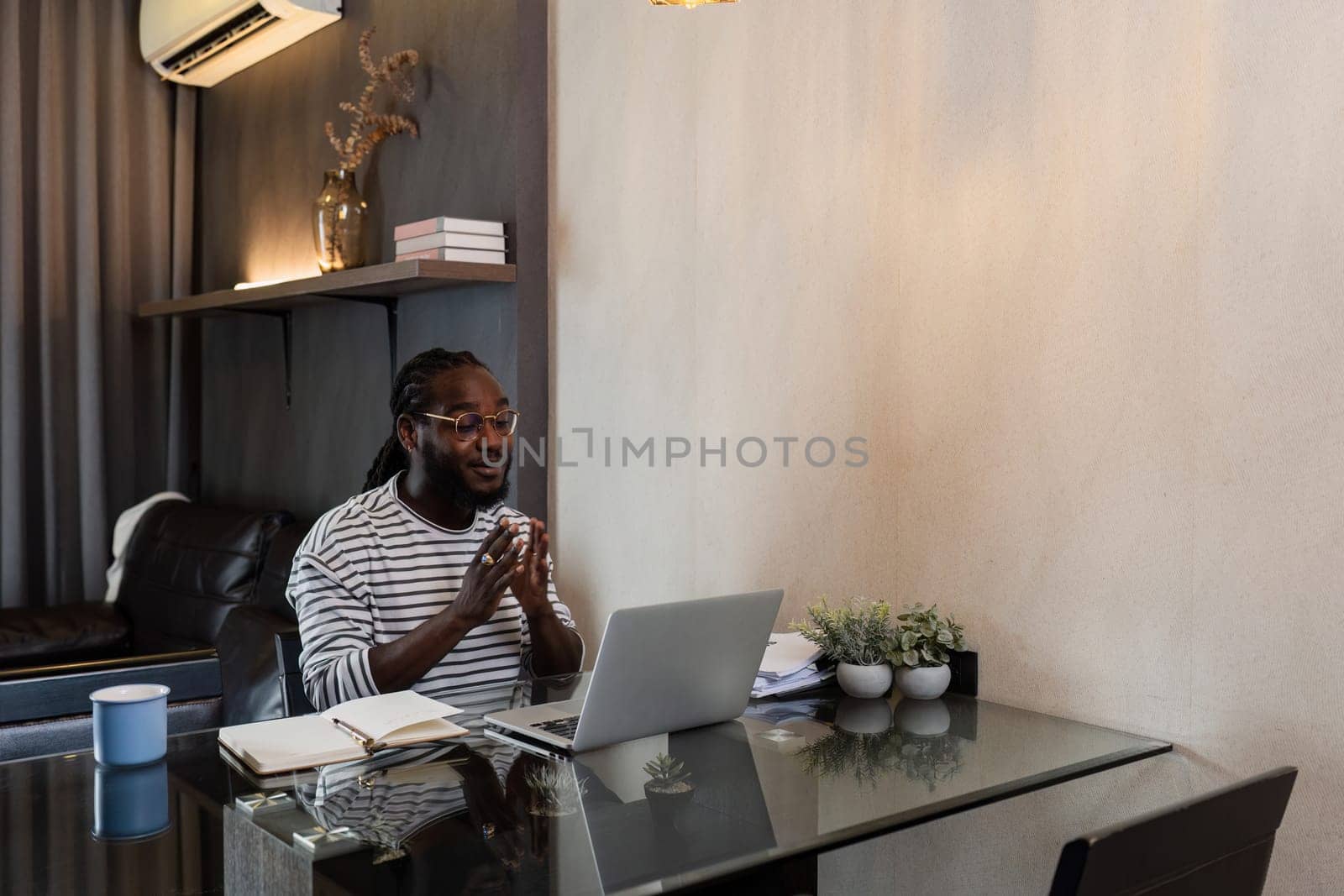 Young African American business man working with laptop and document on desk at home. work from home concept.