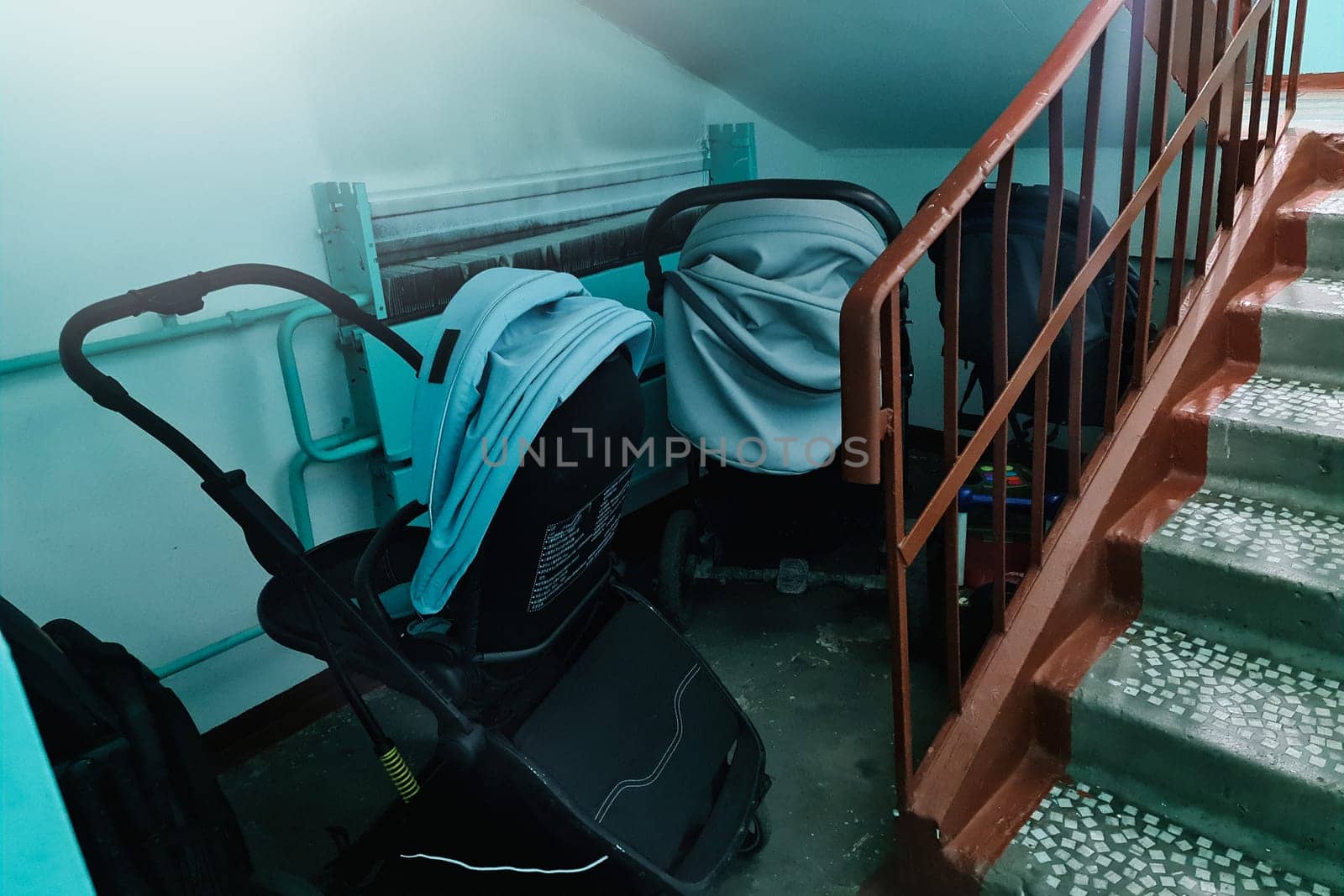 Storing baby strollers in the entrance of an apartment building by Rom4ek