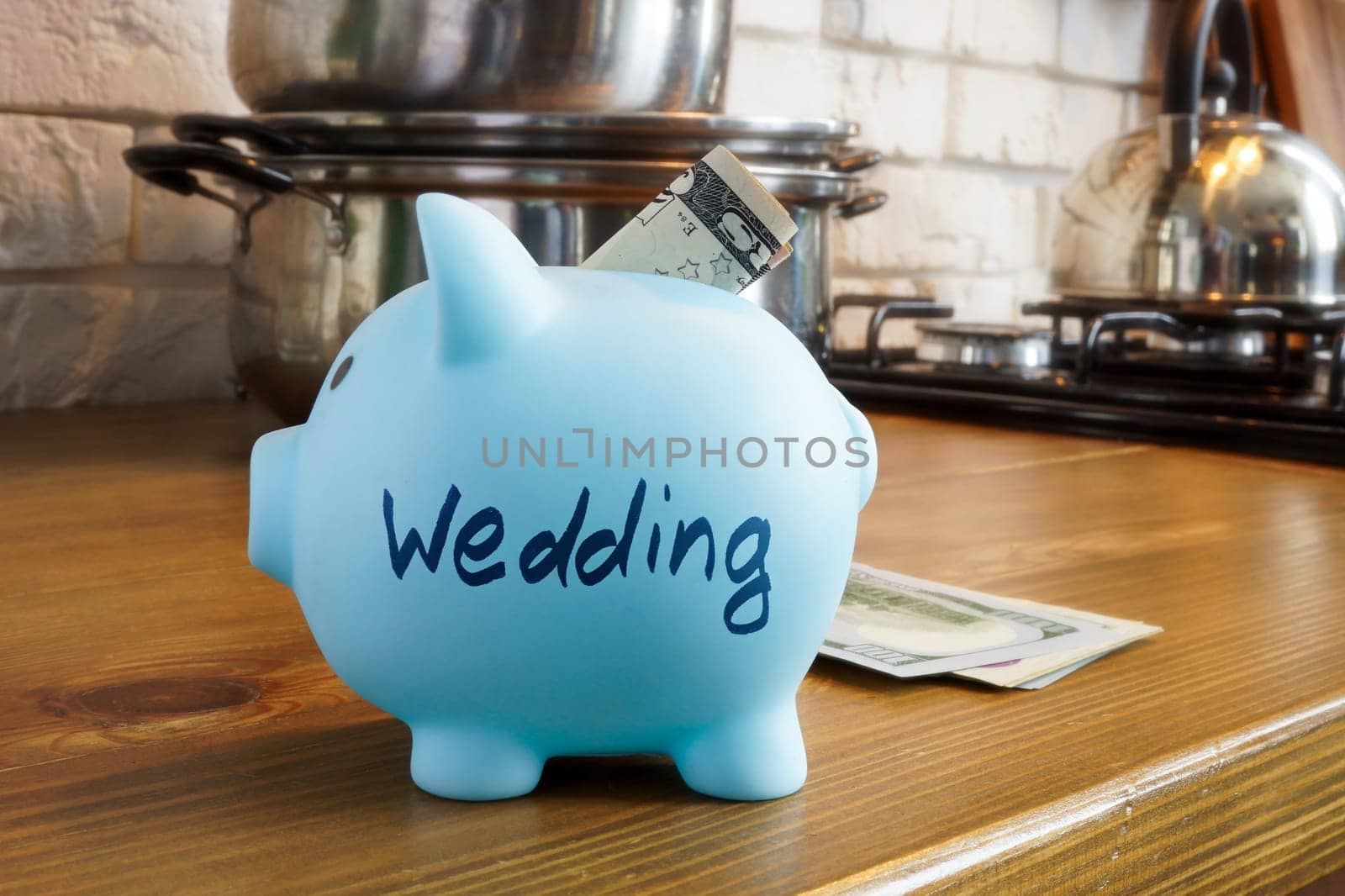 Savings piggy bank with the inscription wedding on the kitchen table. by designer491