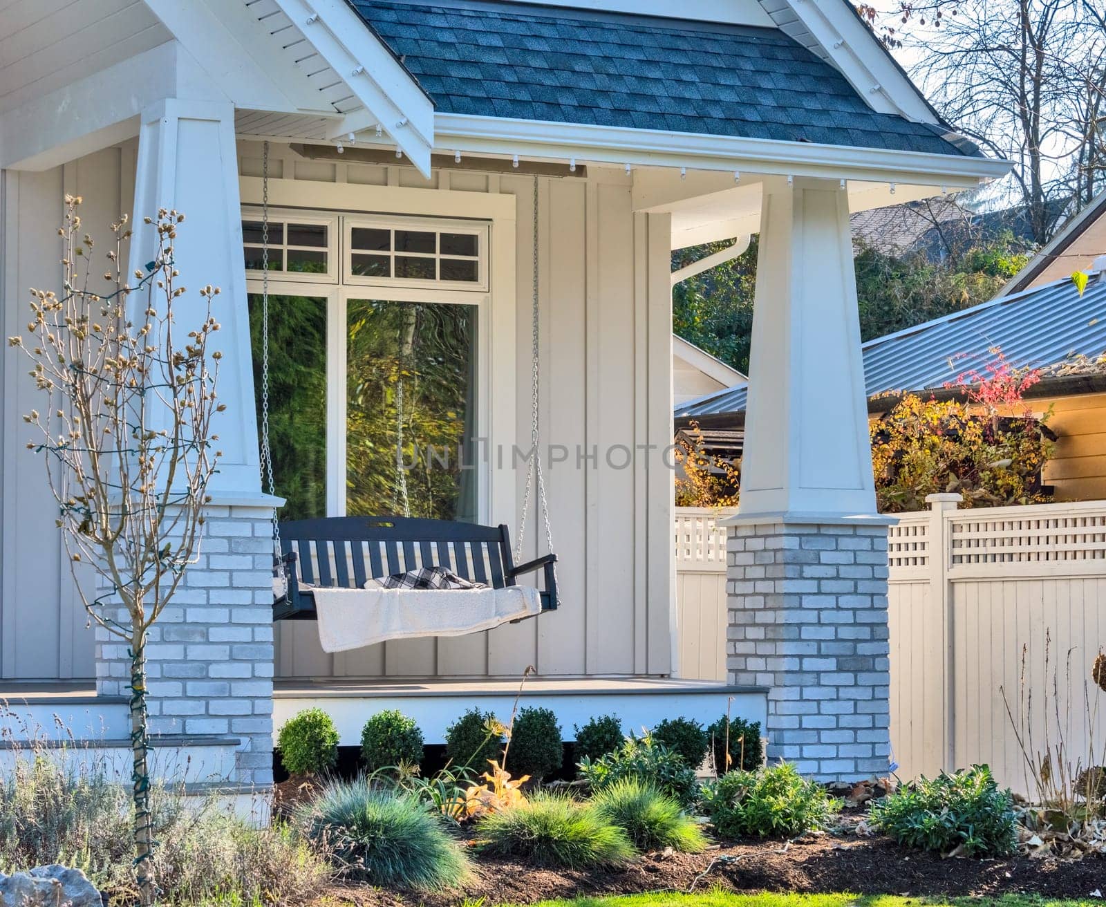 Luxury family house with swinging bench on the open patio.