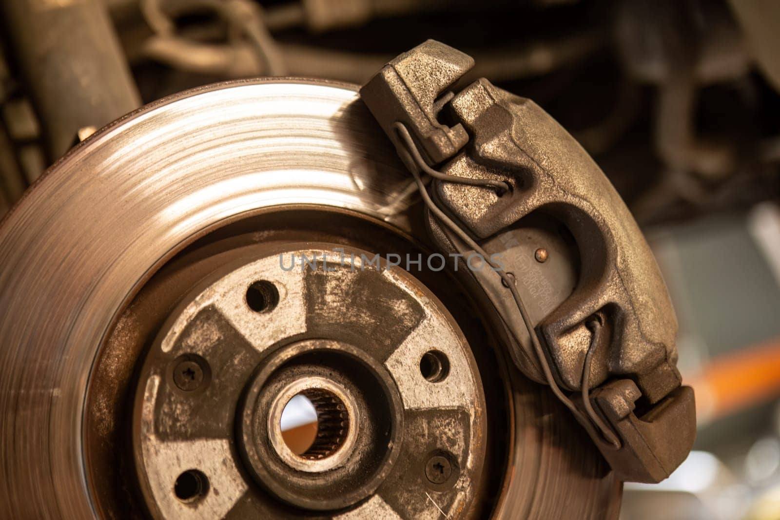 A detailed close-up view of a brake system on a vehicle, showcasing intricate mechanical components in motion.