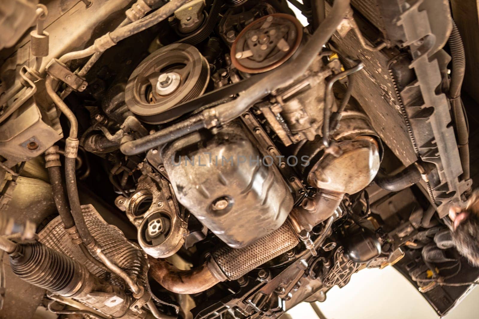 A car engine disassembled in a workshop, highlighting the complexity of automotive repair.