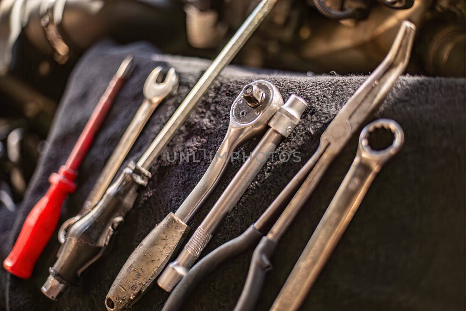 Tools of various shapes and sizes neatly arranged on a wooden table.