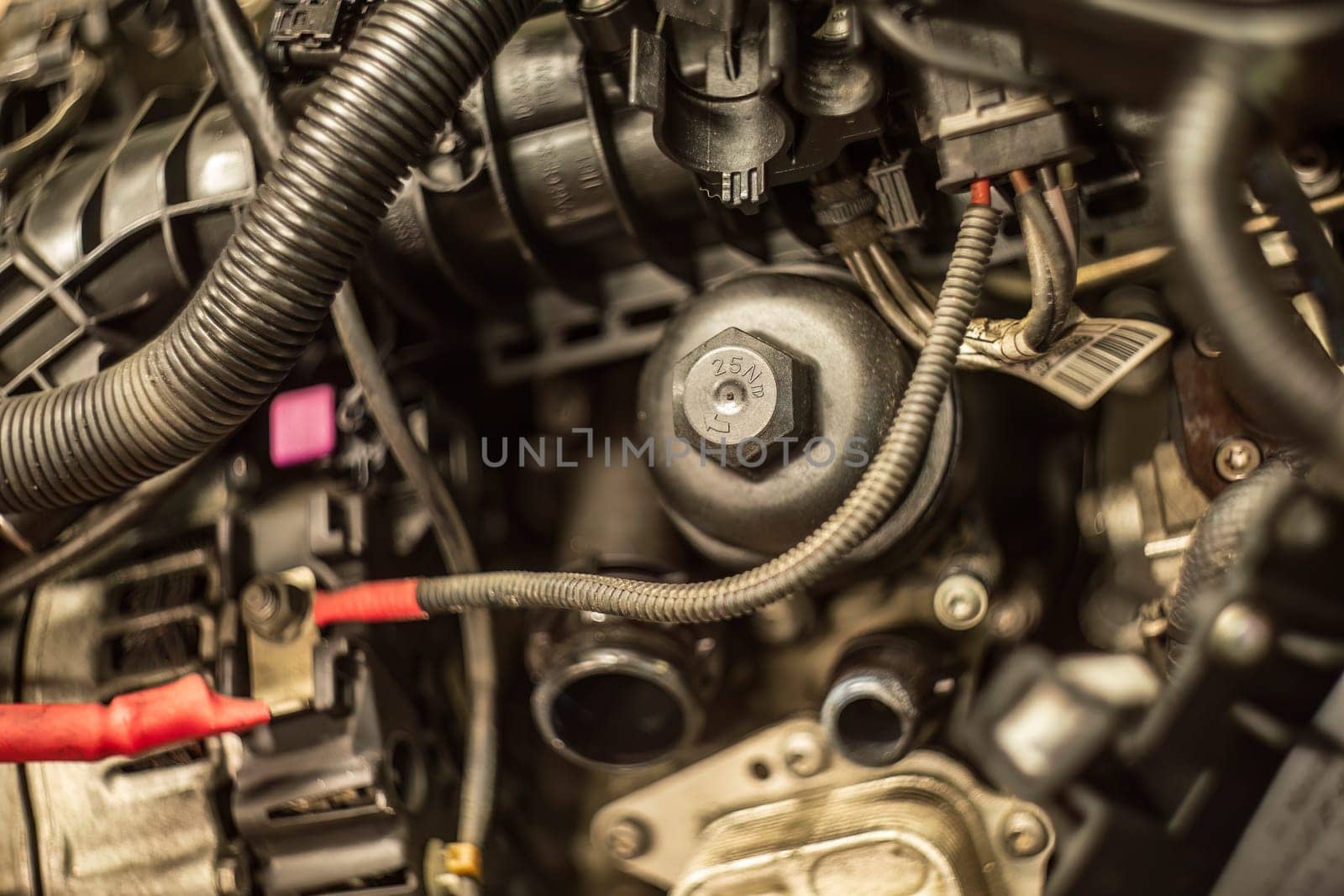 Close-up of a car engine's oil filter cap, essential for proper lubrication and maintenance.