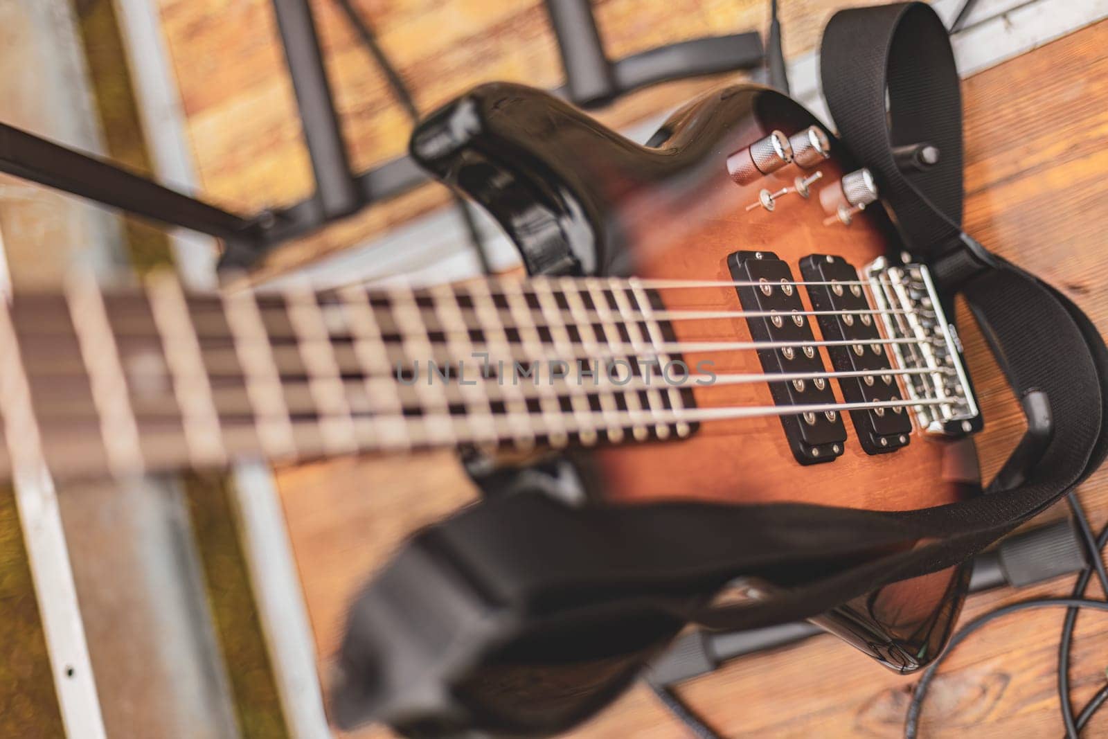 Electric Bass Guitar Hanging on Wall by pippocarlot