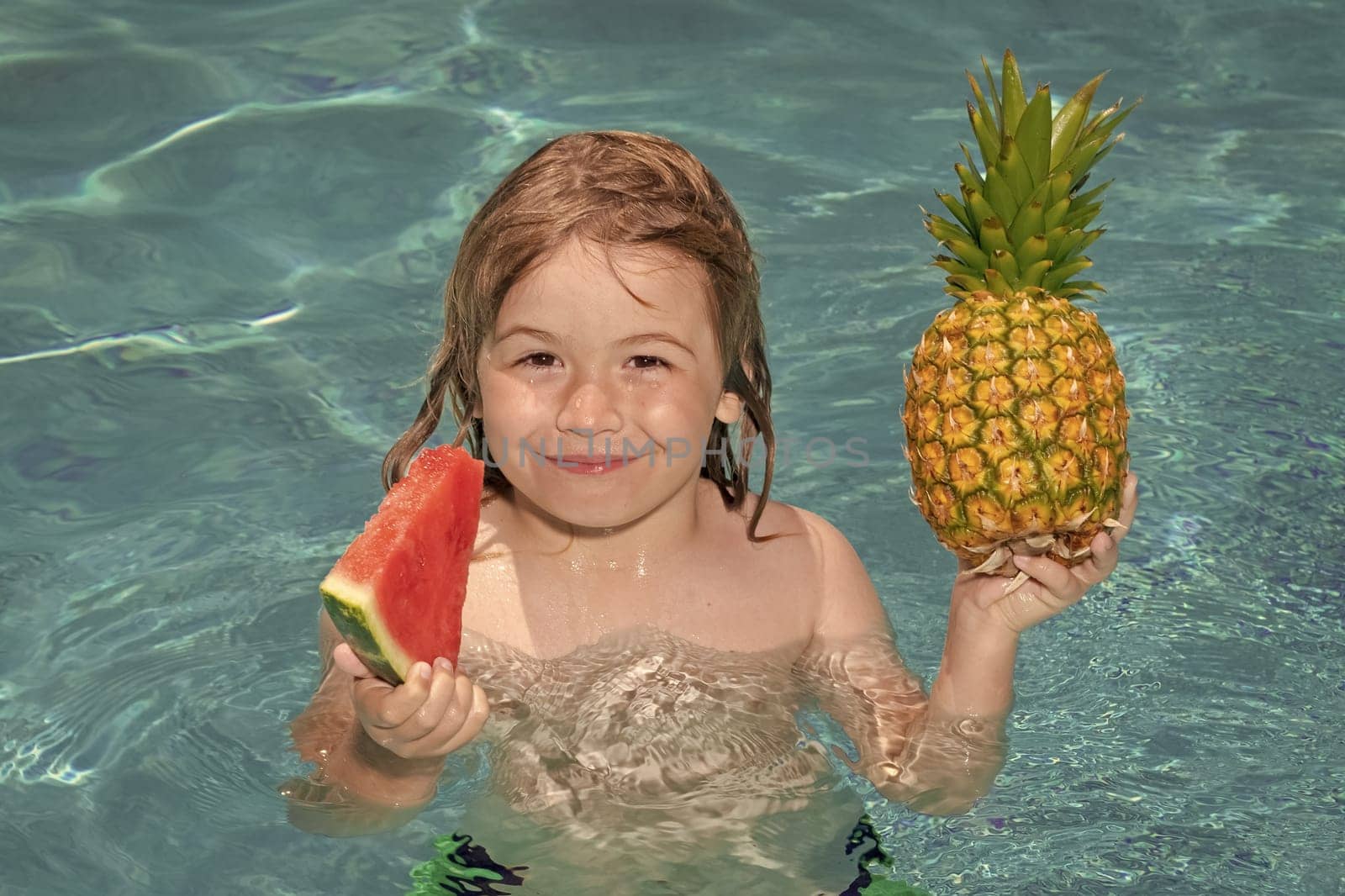 Happy child playing in swimming pool. Summer kids vacation. Summer pineapple amd watermelon fruit for children. by RedFoxStudio