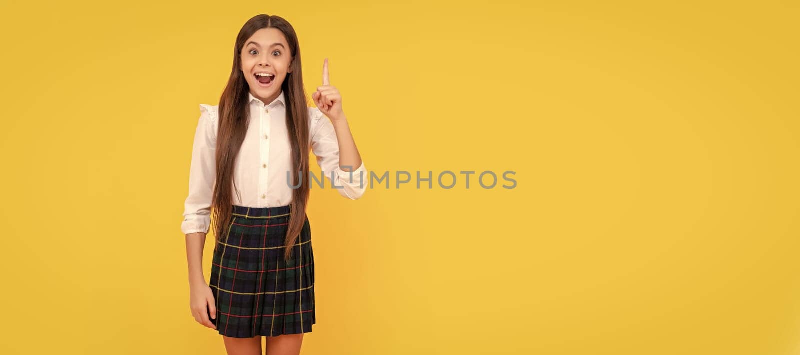 happy kid in school uniform full length inspired with idea on yellow background, idea. Child face, horizontal poster, teenager girl isolated portrait, banner with copy space. by RedFoxStudio