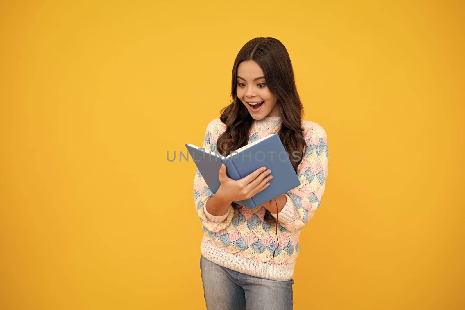 Excited face. Teen girl pupil hold books, notebooks, isolated on yellow background, copy space. Back to school, teenage lifestyle, education and knowledge. Amazed expression, cheerful and glad. by RedFoxStudio