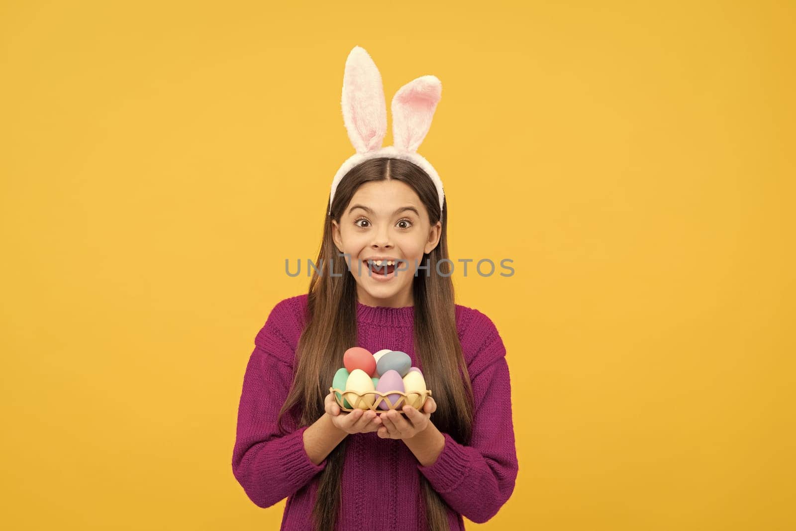 surprised easter teen girl in funny bunny ears hold painted eggs, happy easter.