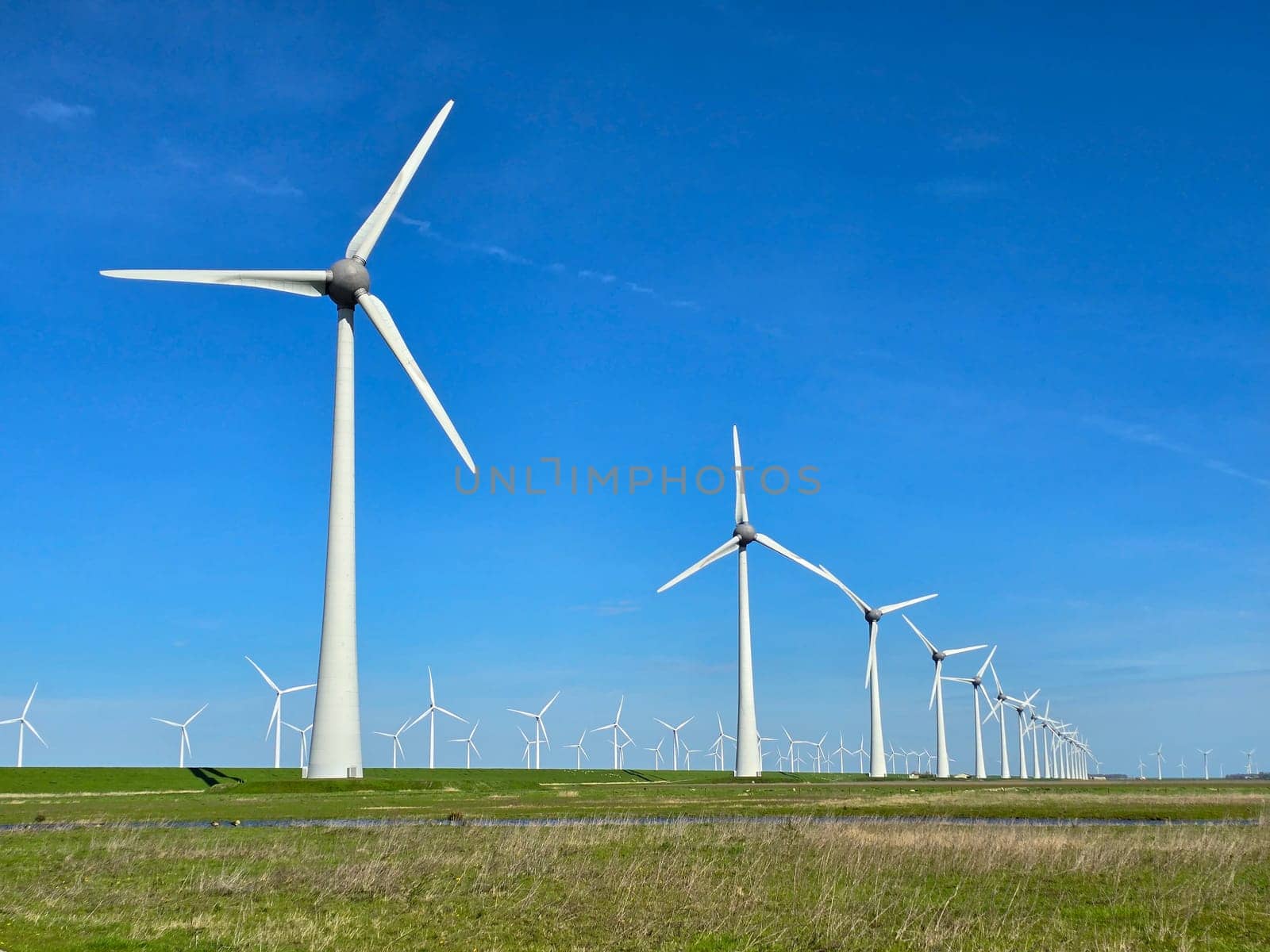 Windmill park in the ocean, drone aerial view of windmill turbines at sea in the Netherlands by fokkebok