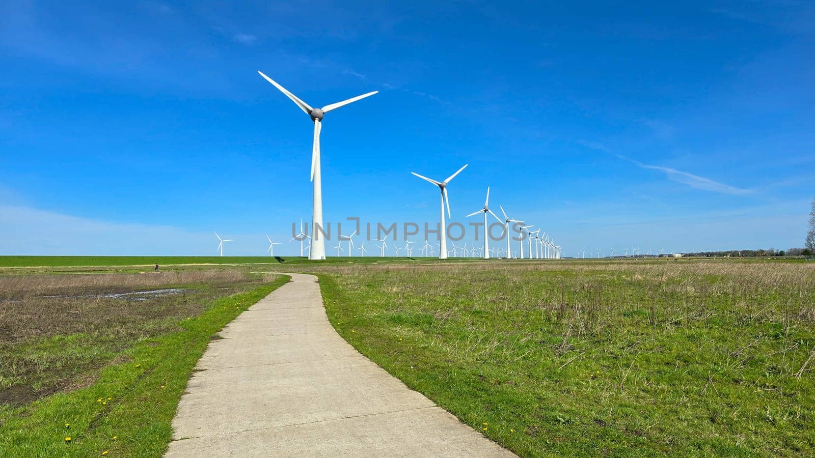 Windmill park in the ocean, drone aerial view of windmill turbines at sea in the Netherlands by fokkebok