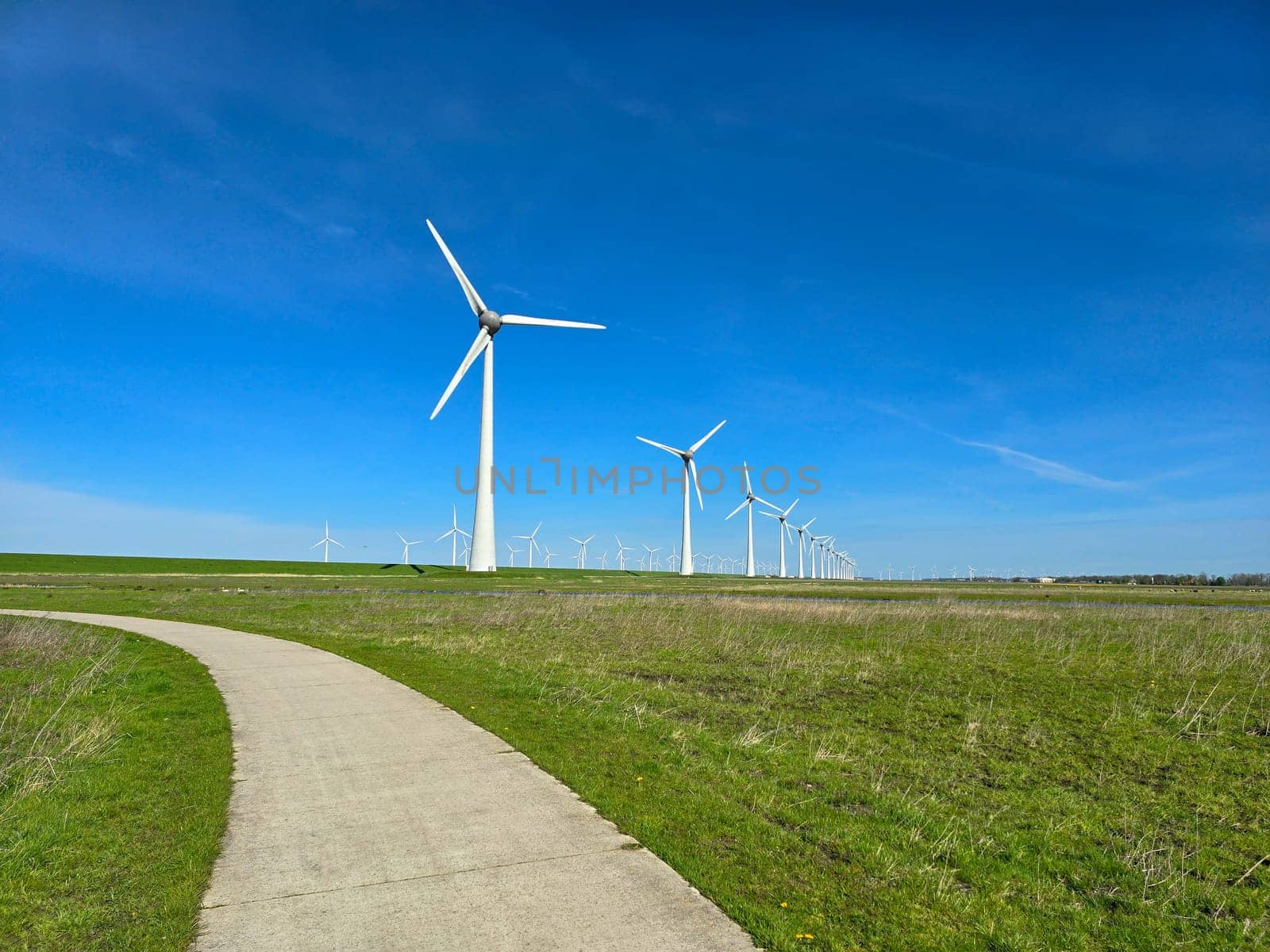 Windmill park in the ocean, drone aerial view of windmill turbines at sea in the Netherlands by fokkebok