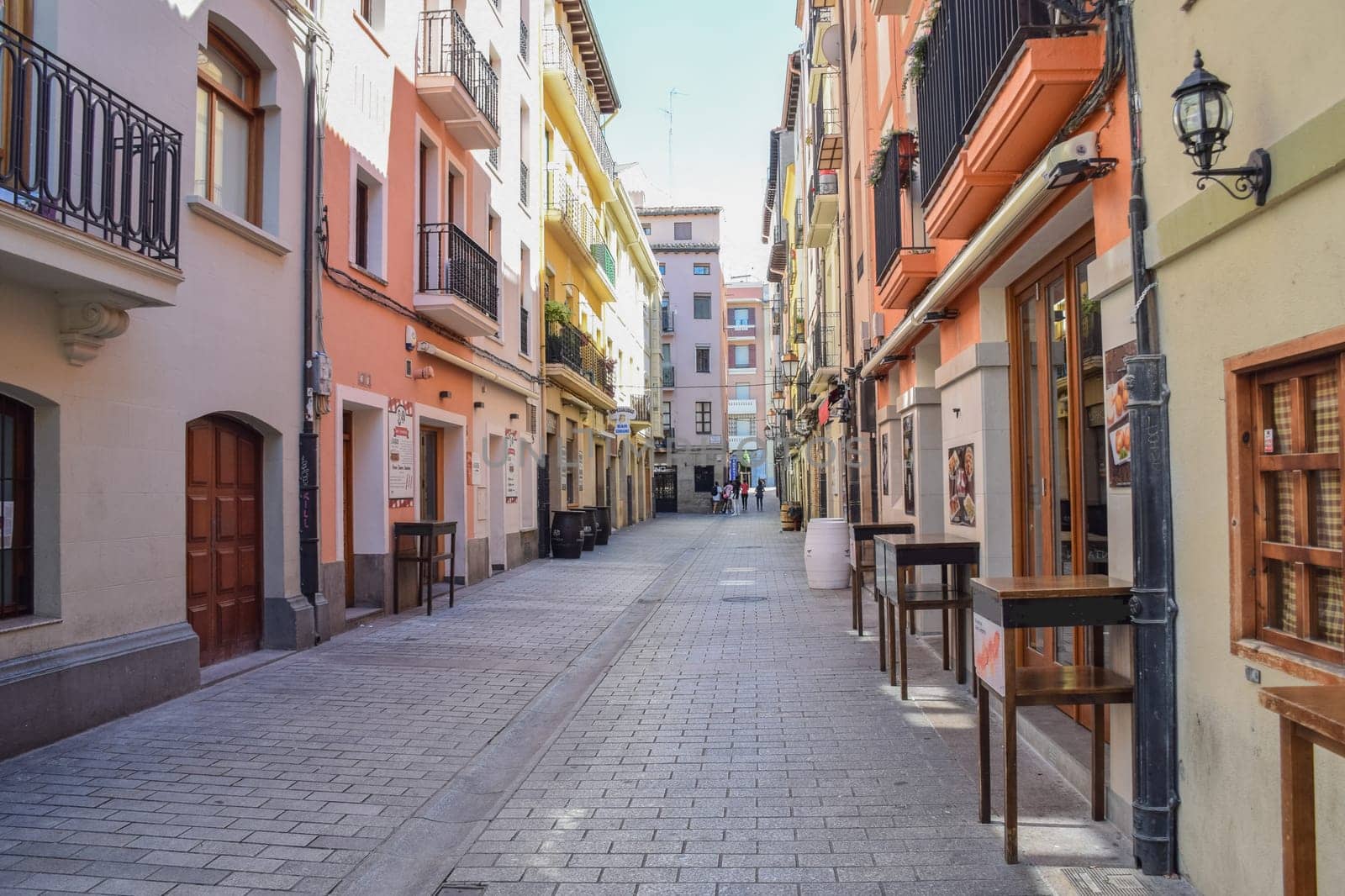 A street in Spain with cafes and restaurants, outdoor bar tables and counters