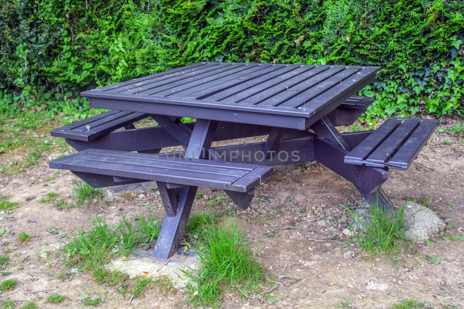 The table outside is wooden, with benches screwed on all sides, France, Saint Jean Pied de Port