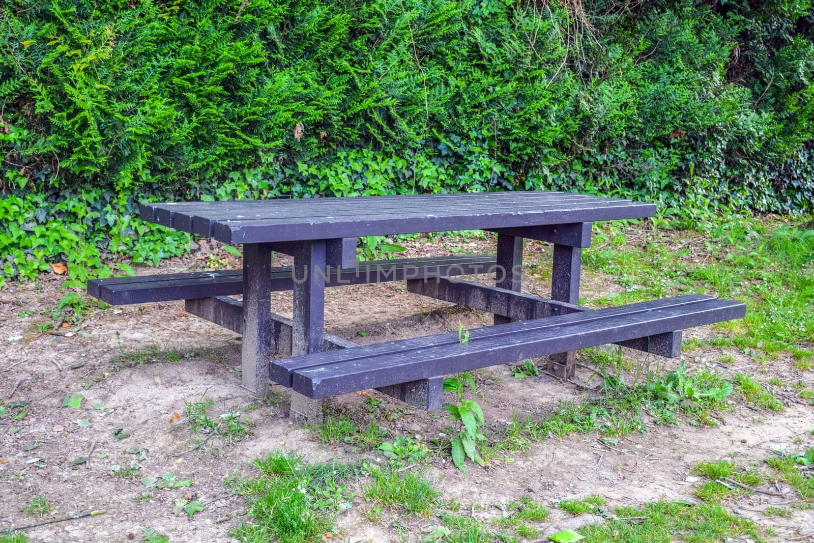 Table outside, black with benches by kempel