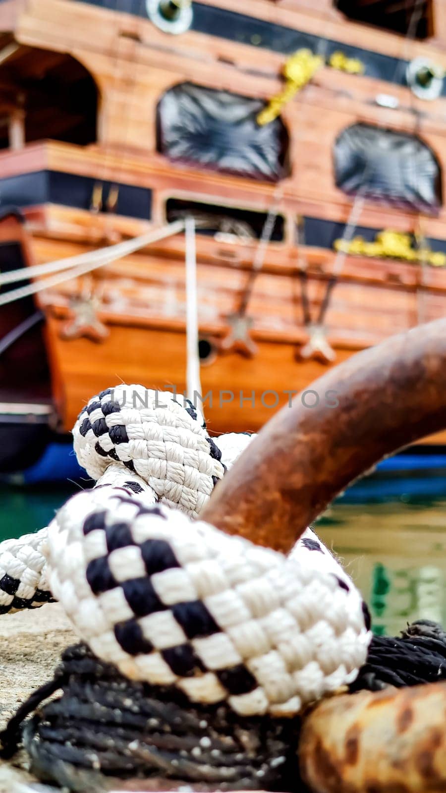 Mooring Knot, Close-Up, from Which Ropes Extend to Stern of Ship Holding it in Bay, Concept of Reliability by Laguna781