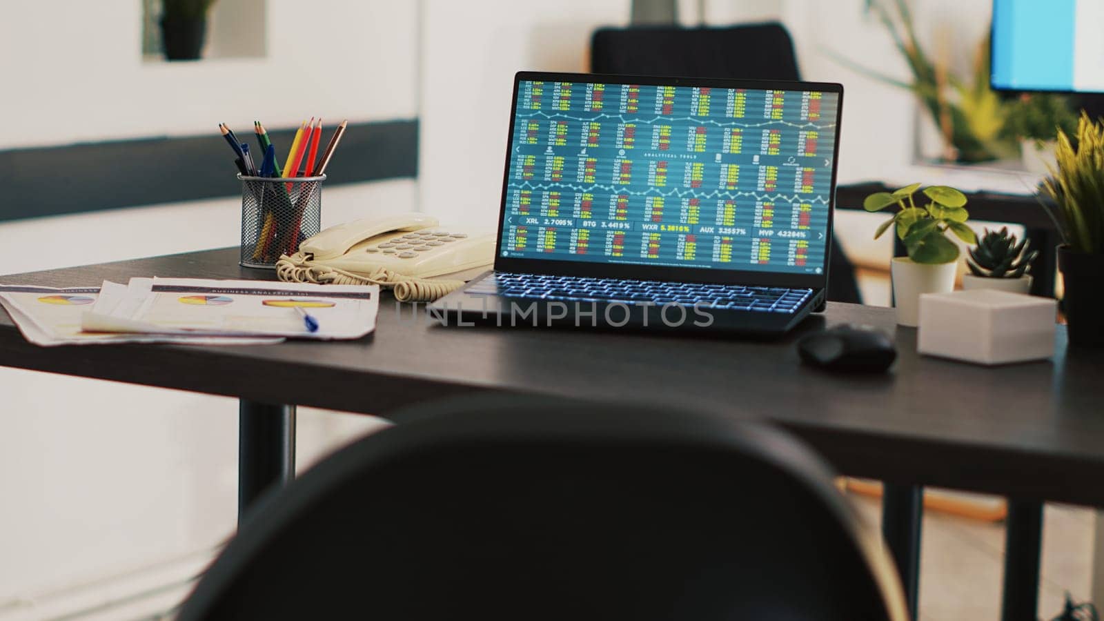 Business analytics files and notebook on desk in company workplace by DCStudio