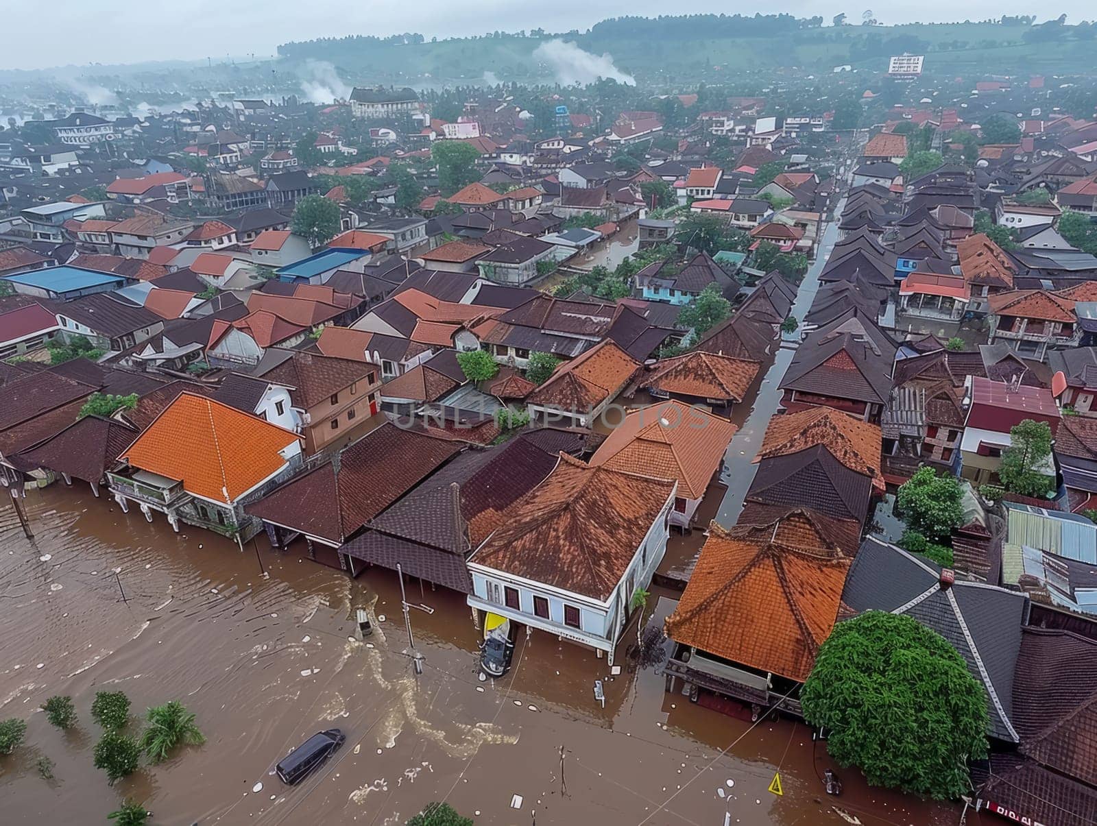 Aerial view of flooding city. Natural disaster damages houses and vehicles. Extreme flood and storm aerial photo. by iliris