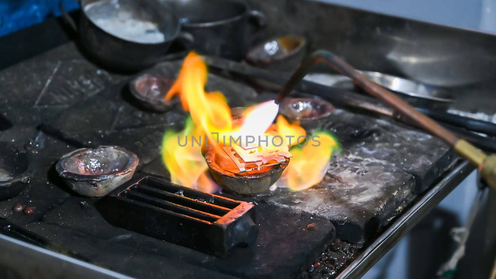 Traditional metalworking with fire on anvil by Peruphotoart