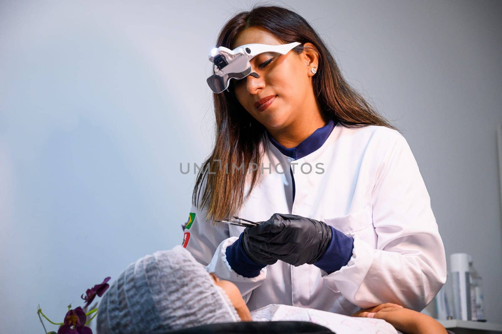 Female dentist examines a patient's teeth in a dental office setting