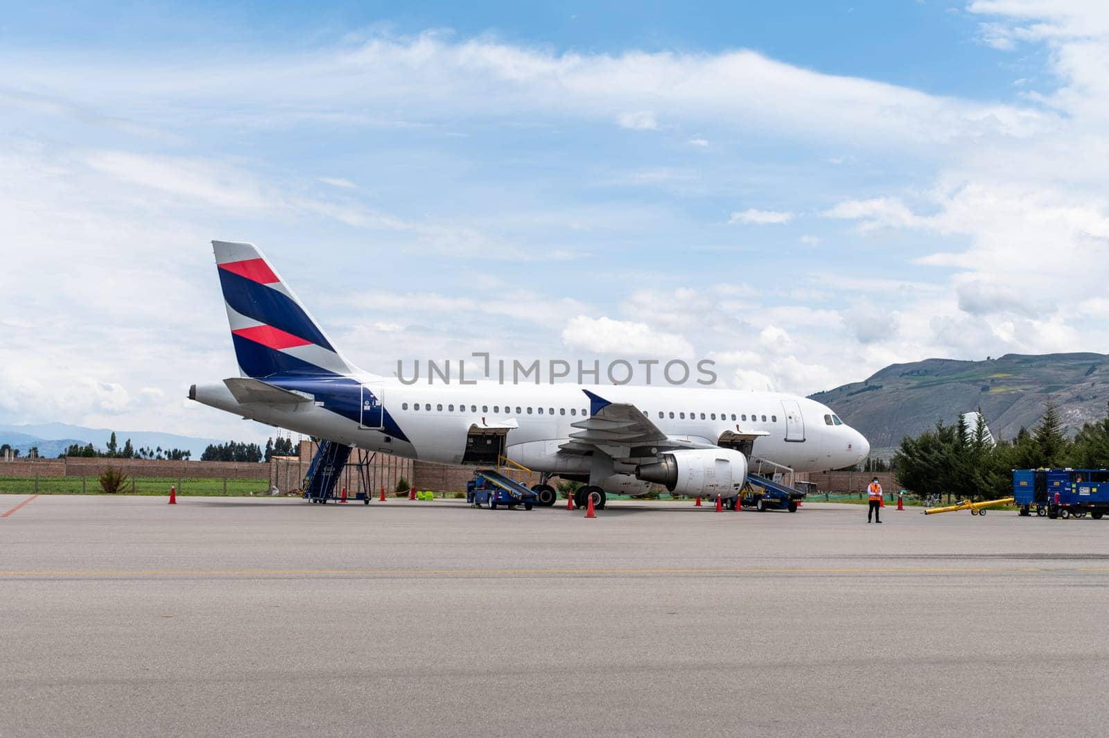 Big white passenger jet plane on runway at the airport on a sunny day. by Peruphotoart