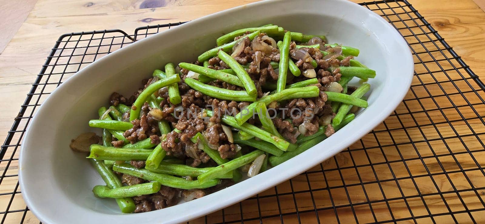 String green bean or french beans with minced beef stir fry or sauteed called Tumis buncis daging sapi cincang in Indonesia, selective focus