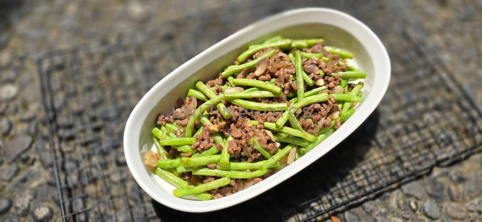 String green bean or french beans with minced beef stir fry or sauteed called Tumis buncis daging sapi cincang in Indonesia, selective focus