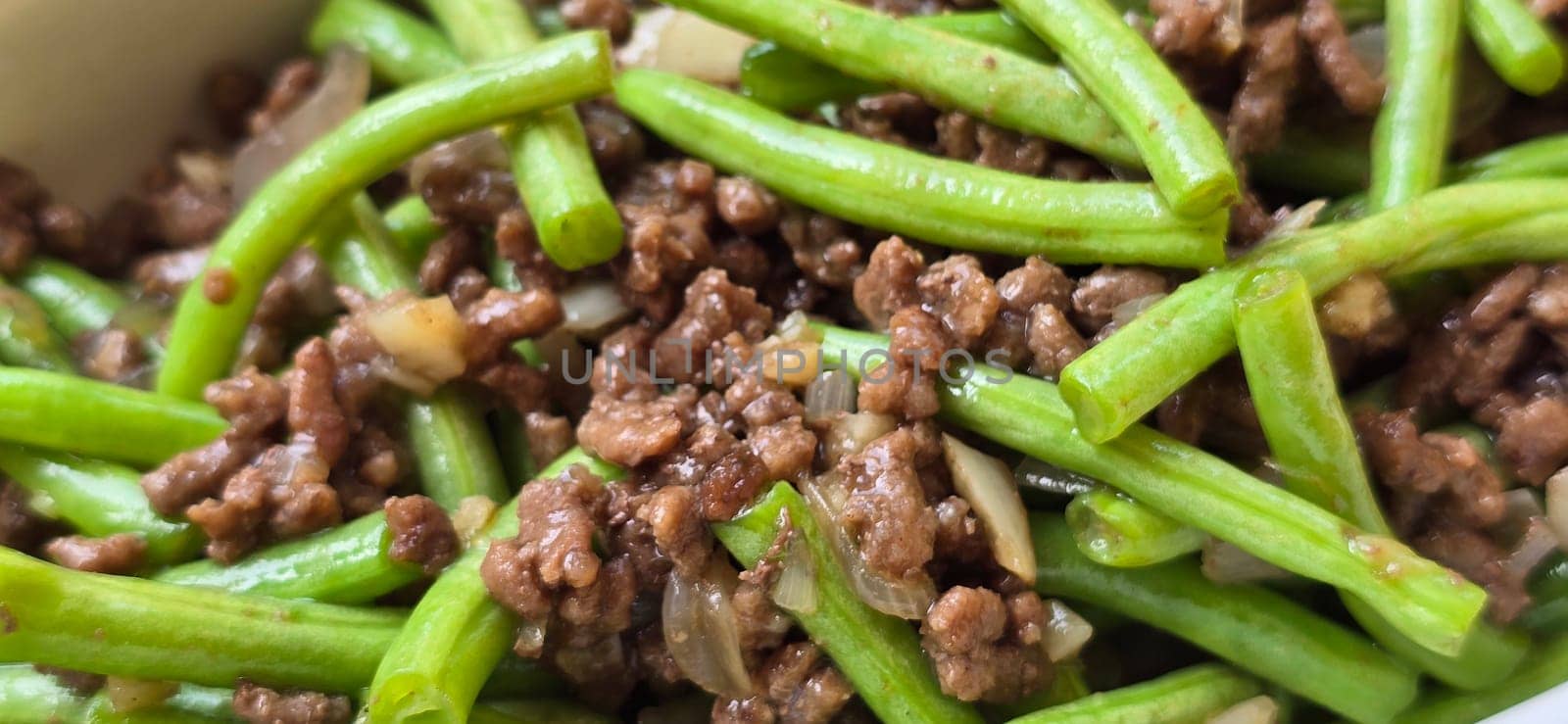 String green bean or french beans with minced beef stir fry or sauteed called Tumis buncis daging sapi cincang in Indonesia, selective focus