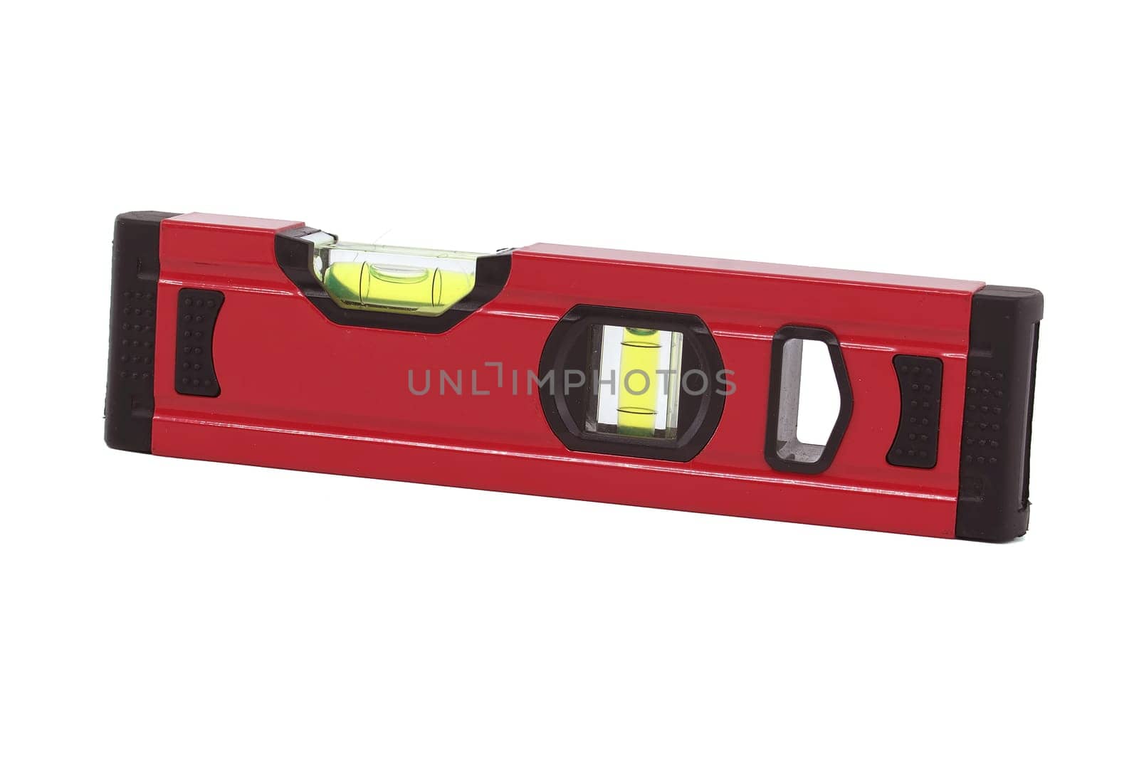 Red spirit level with a green bubble indicator is situated horizontally on a white background