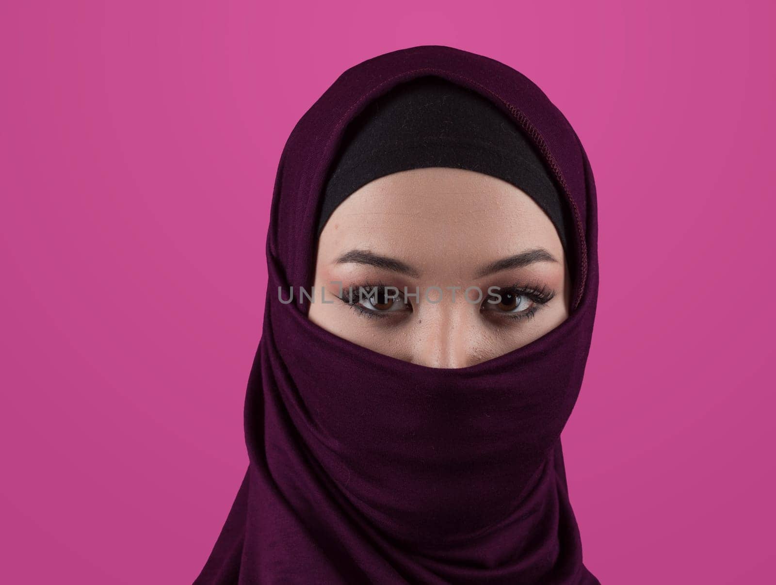 Modern Muslim woman wearing stylish hijab casual wear isolated on pink background. Diverse people model hijab fashion concept. High quality photo